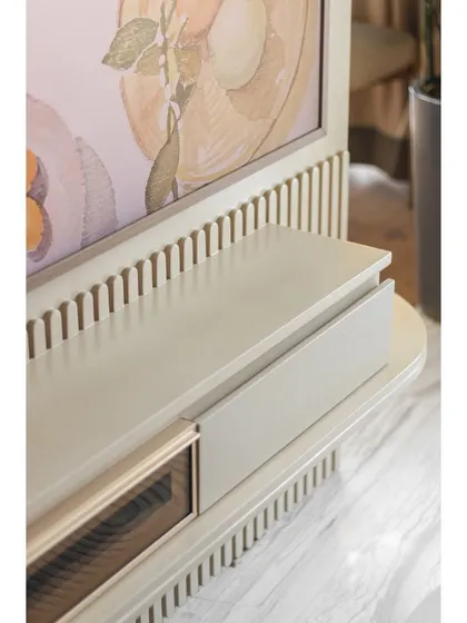 The sleek TV unit is framed with fluted detailing, echoing the design elements used throughout the apartment and ensuring a cohesive look.