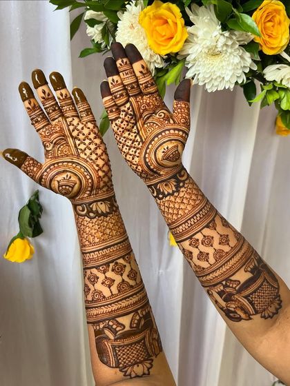 A clear, bright shot of the full-arm mehendi, highlighting the clean lines and intricate details.