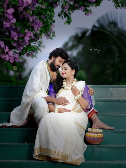 A beautiful outdoor portrait inspired by the mythological character Shakuntala. The white saree with jasmine flowers and the natural green backdrop create a serene and poetic image.
