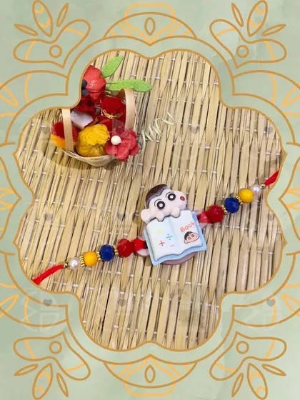 For the little ones, I design these cute and playful rakhis, like this one featuring a monkey reading a book. It's sure to bring a smile to your little brother's face.