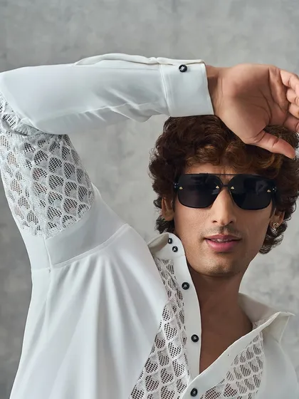 A close-up of our white shirt with unique mesh-like detailing on the sleeves and chest, perfect for a casual yet elevated look.