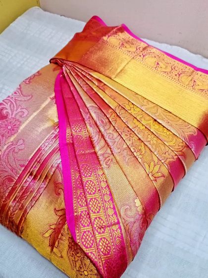 Another view of the pink and gold silk saree, pleated and box-folded. It's ready to be stored or packed without any worry of creases.