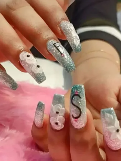 Another view of the personalized initial nail art, showing how the design looks across both hands.