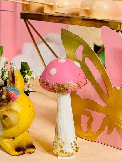 The devil is in the details. This little mushroom prop, part of a whimsical fairy theme, adds a touch of magic and helps build a complete, enchanting world for the celebration.