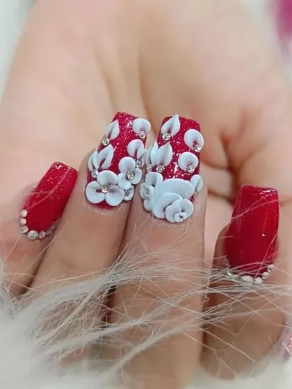 Another view of the stunning red and white 3D floral nails, showcasing the dimension and sparkle.