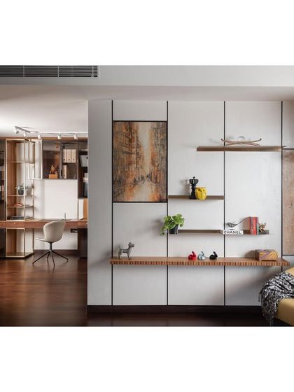 A view from the living area into the integrated home office. We used a glass and wood partition to maintain a sense of openness while creating a dedicated workspace. The design ensures that even functional areas are aesthetically pleasing and connected to the rest of the home.