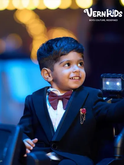 A close-up of the birthday star. Our tuxedos are detailed with accessories like this lapel pin and perfectly tied bow tie to complete the formal look.