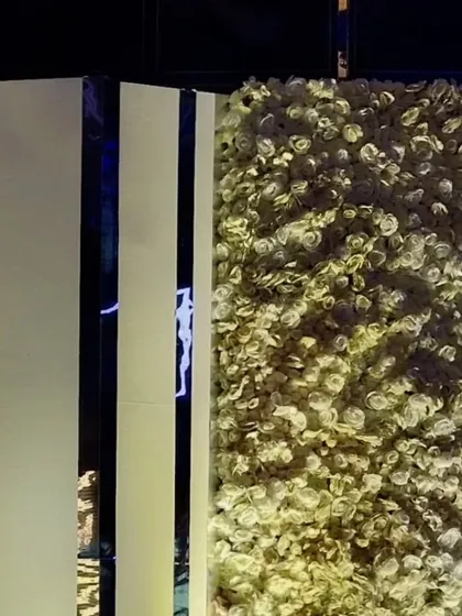The texture and detail of the flower wall and modern paneling, showcasing the quality of the materials and fabrication we use to bring our designs to life.