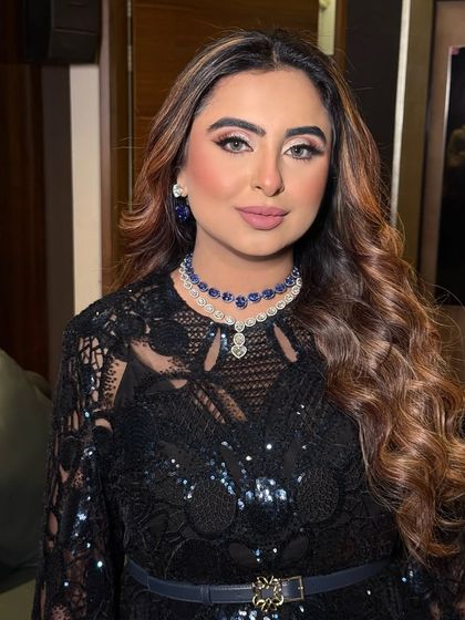 The focus is on the eyes and the stunning jewelry. The makeup is blended perfectly to create a sophisticated and alluring effect.