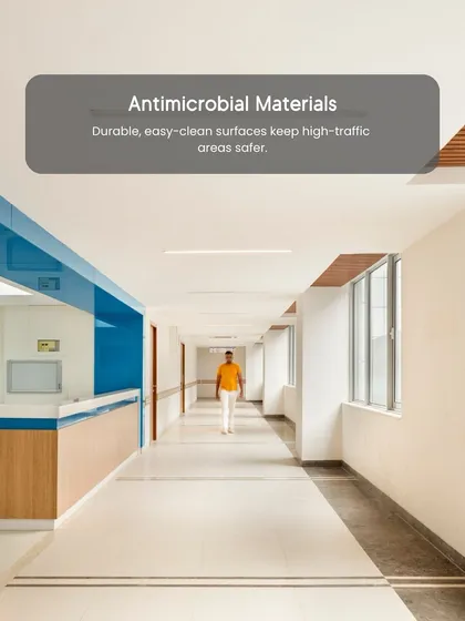 Antimicrobial materials are a key innovation for safer healthcare interiors. We specify durable, easy-to-clean surfaces for high-traffic areas like this corridor to minimize the spread of infection.