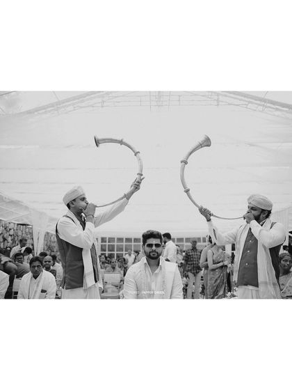 A powerful black and white shot of the traditional horn blowers, capturing the cultural richness of the ceremony.