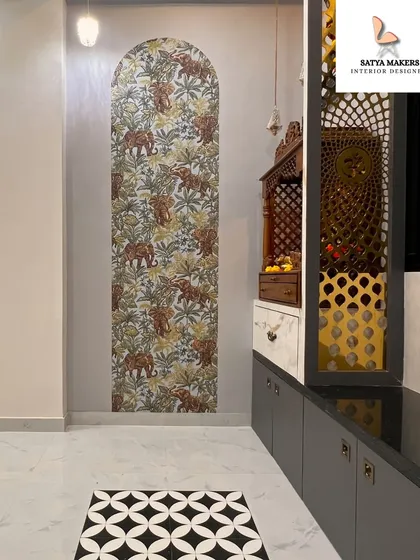 An artistic approach to a spiritual corner, featuring an elephant-patterned wallpaper in an arched niche next to a custom pooja unit.