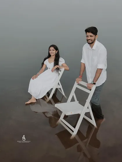 A duplicate of 305, a creative shot with the couple and chairs in the lake water.