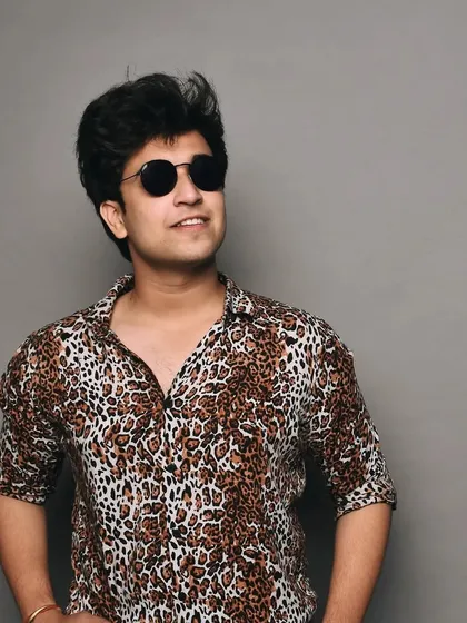 A studio shot in a cheetah print shirt and sunglasses. This look is bold and confident, suitable for edgy fashion and lifestyle brands.