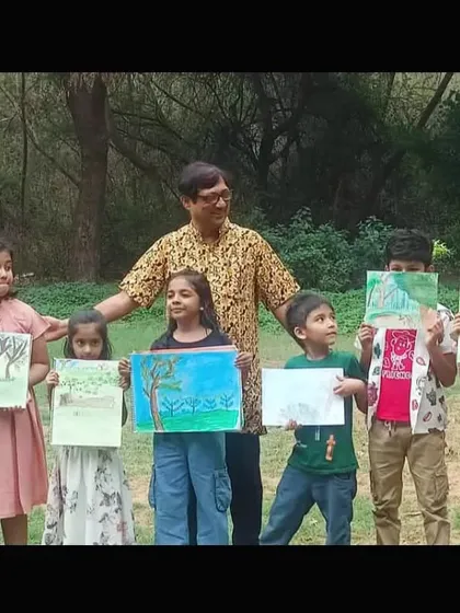 A group of our younger students proudly displays their tree drawings, created during the outdoor nature study session with their instructor.