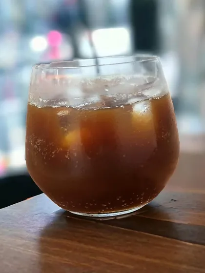 My Espresso Tonic is a crisp and refreshing beverage. A shot of espresso is poured over bubbly tonic water and ice, creating a zesty and energizing drink.