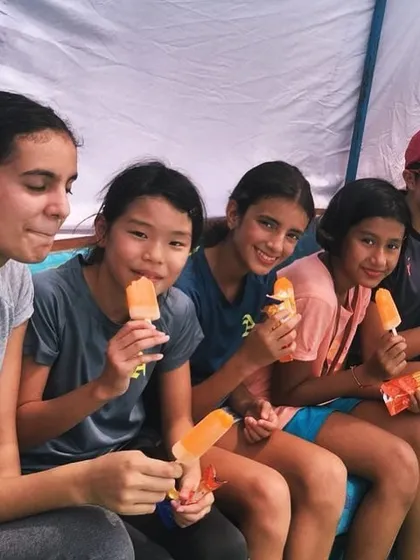 A happy swimmer is a fast swimmer. While we train with intensity, we also build a strong, supportive team environment. Here, some of our national medalists take a well deserved break to enjoy ice pops together, celebrating their hard work and friendship.