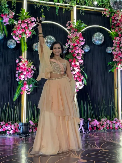 A cheerful pose in my peach gown, ready to take the stage for a night of Sangeet performances.