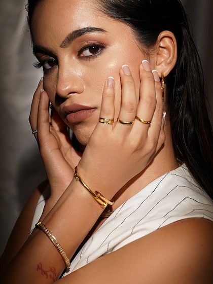 A portrait of modern beauty, adorned with our minimalist gold rings and bracelets.