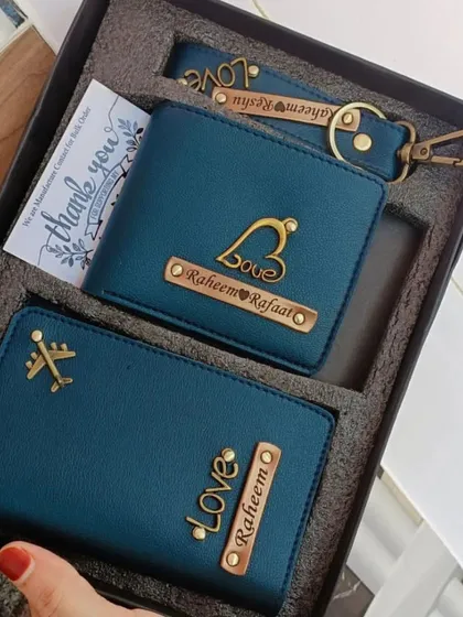 A beautiful couple's gift set in teal, featuring a personalized wallet, passport holder, and keychain, all with matching 'Love' charms.