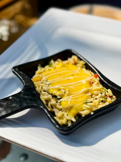 A close up of the Parolina Orzo with Thai pumpkin sauce, showcasing the creamy texture of the sauce drizzled over the pasta and vegetables. It's a comforting yet exotic dish that always gets rave reviews.