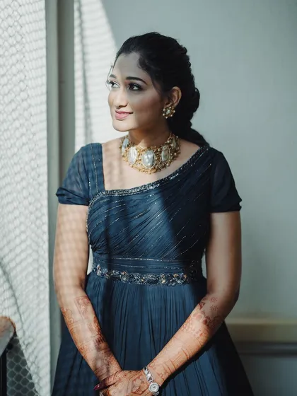 For a welcome event or a cocktail party, a sophisticated gown look is a wonderful choice. I gave my bride Surabhi a soft, glowing makeup look with a simple, elegant hairstyle to match her beautiful navy blue gown.
