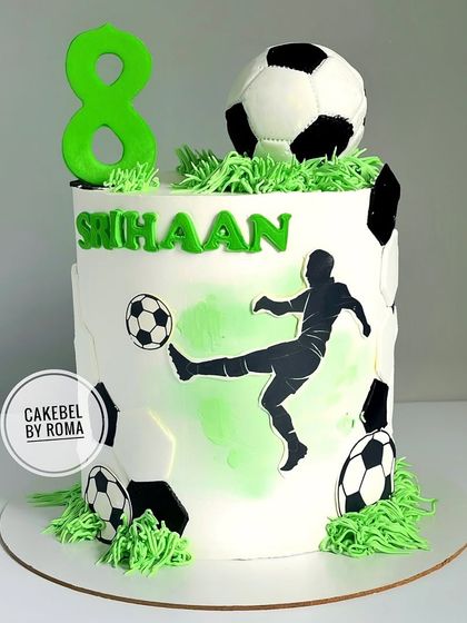 A clean and modern football cake for Srihaan's 8th birthday. The design features a silhouette of a player in action, a 3D fondant soccer ball, and edible grass.