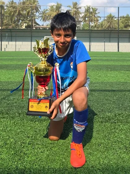 A kneeling pose with the trophy from a U14 Tigers player.