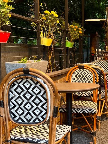 My outdoor seating area is perfect for enjoying a sunny day. The colorful pots and stylish chairs create a cheerful atmosphere.