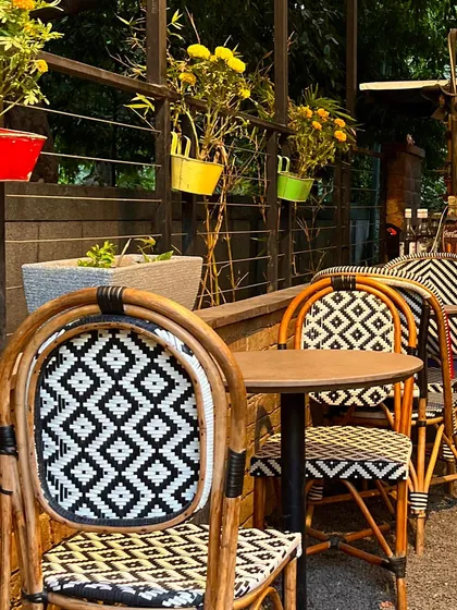 My outdoor seating area is perfect for enjoying a sunny day. The colorful pots and stylish chairs create a cheerful atmosphere.
