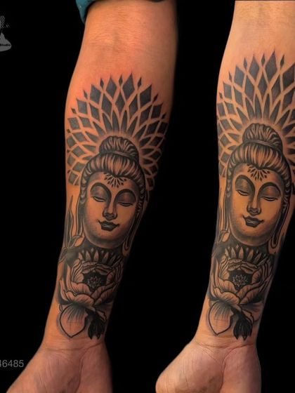 A beautiful Buddha tattoo sleeve, showing his face in a state of serene meditation. The geometric halo and lotus in his hands add layers of spiritual symbolism, representing purity and enlightenment.