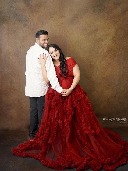 A tender and loving embrace. The mom-to-be leans back against her partner, creating a portrait that speaks of trust, support, and shared joy.