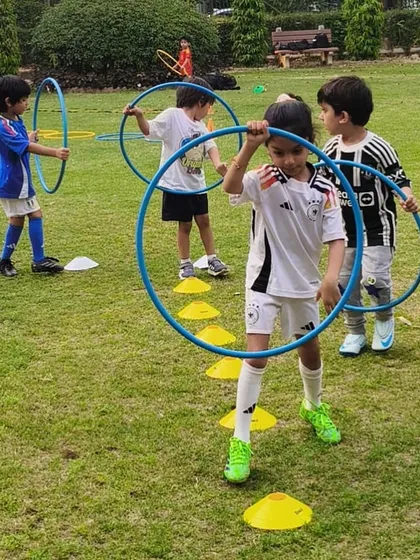 A moment of focus from one of our youngest players as he carries a hula hoop through a drill, learning to follow instructions and complete a task.