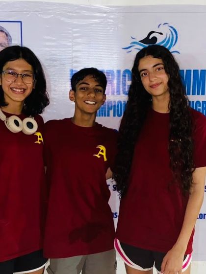 Three of my champion swimmers, all smiles after a successful competition. The bond they share as teammates is a key part of our academy's culture.