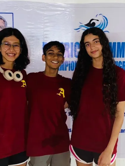 Three of my champion swimmers, all smiles after a successful competition. The bond they share as teammates is a key part of our academy's culture.