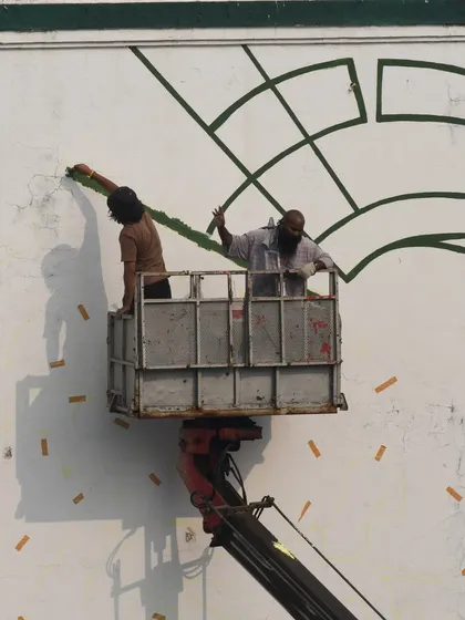 A process shot of me and my partner working on the horse mural from the crane. It took us three days, but the result was worth it.