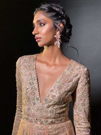 An elegant and shimmering look for Ritu Kumar. The makeup is soft and romantic, with a focus on glowing skin to complement the heavily embellished gown.