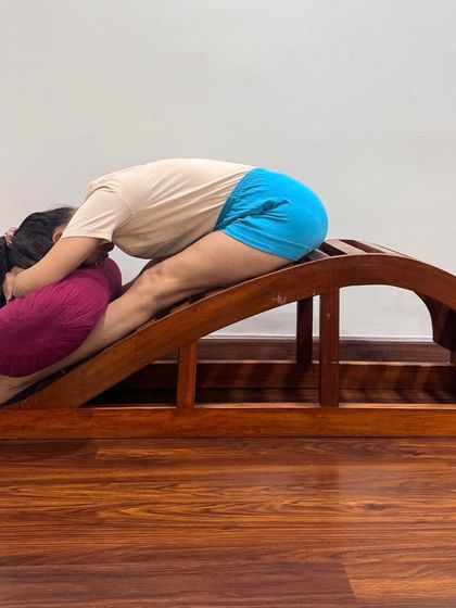 Another variation of a supported forward bend on the backbend bench. These modifications help to adjust the anatomical structure, balancing the inner and outer muscles evenly.