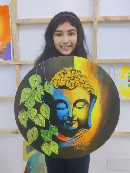 A serene Buddha painting on a round canvas, beautifully executed by one of our young students. Our classes often explore spiritual themes, providing a calm and meditative experience.