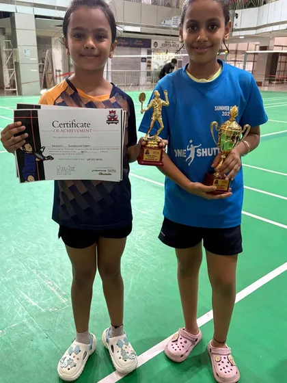 Celebrating the success of our junior shuttlers. Two of our students proudly display their trophies and certificates after a fantastic performance in the Racket Rider Tournament.