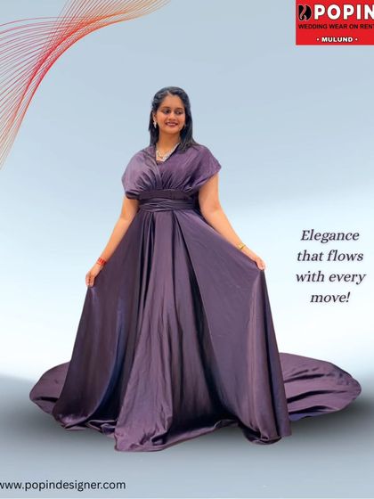 "Elegance that flows with every move". This image captures the luxurious feel of the purple satin gown, perfect for making a memorable entrance.
