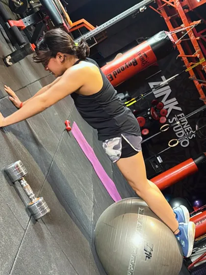 This is an advanced push-up variation using a stability ball. By placing her feet on the ball, this client is challenging her core and shoulder stability far more than in a standard push-up.