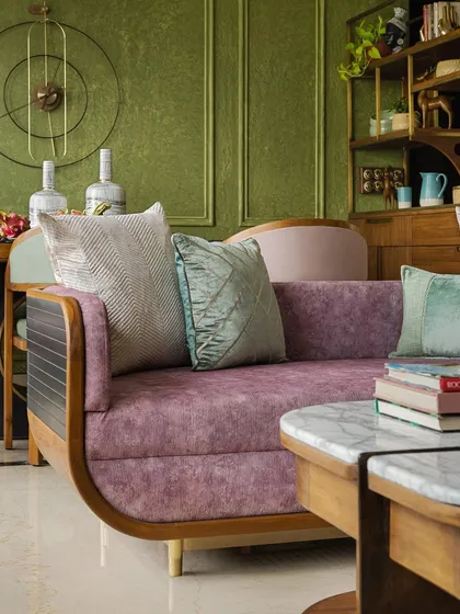 A custom sofa in a mauve fabric, adding a soft touch to the eclectic living space.