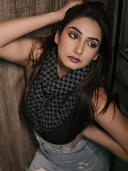 A casual portrait with a focus on personal style. The use of a scarf and denim creates a look that is both fashionable and accessible.