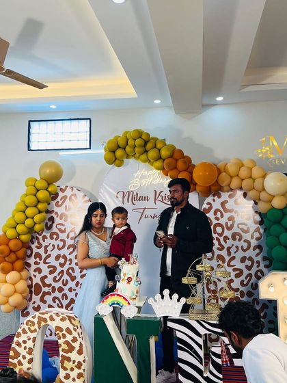 The family celebrating at the jungle-themed first birthday party. My decorations create a festive and memorable setting for your family photos.