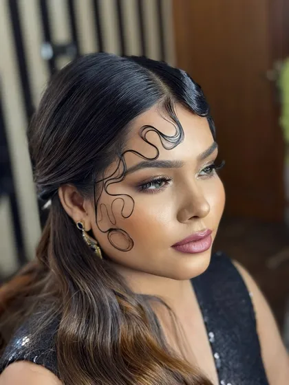 A close up of sculpted finger waves on the hairline. This retro detail adds a high fashion touch to any updo and is a specialized technique we cover.