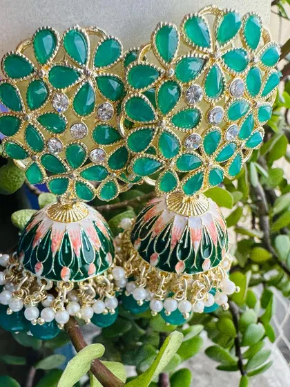 My Meenakari jhumkas are a mood lifter, and this green pair is a perfect example. The detailed floral stonework and hand-painted enamel dome bring a pop of color and traditional artistry to your look.