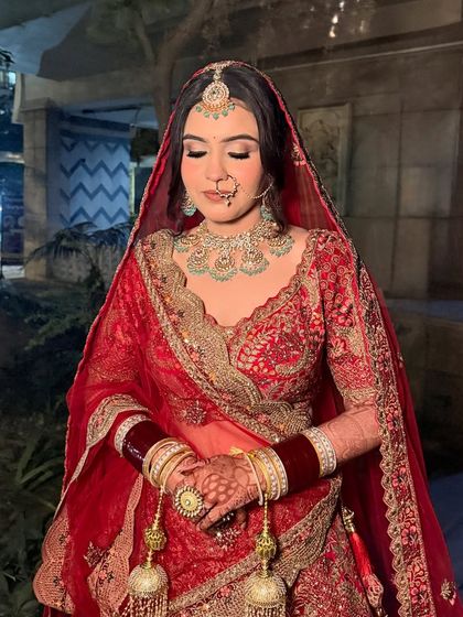 The complete bridal look for Parul. We went for a classic red lehenga with soft, defined eyes and a flawless base, creating a timeless and elegant appearance for her pheras.