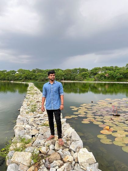 Pausing to enjoy the view of the calm water and the greenery on the opposite bank.