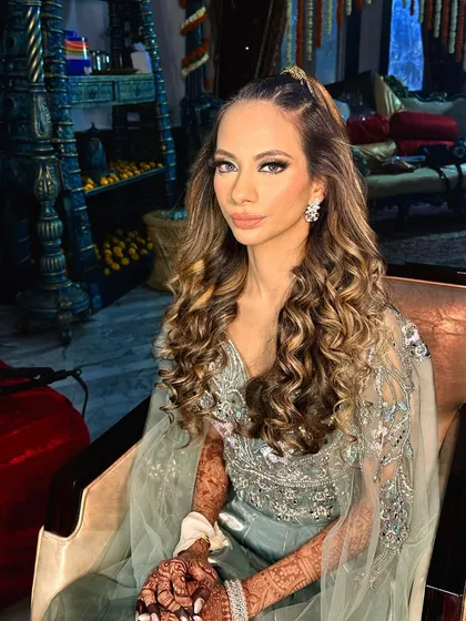 This sangeet bride from London wanted a modern, chic look. I gave her voluminous curls with a stylish half-ponytail and a smokey eye that made her features pop.